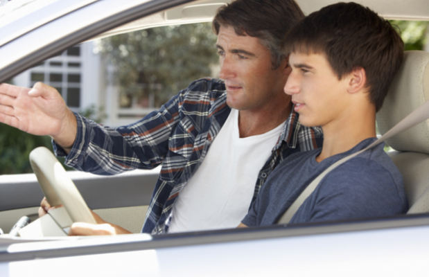 Dad coaching teen son driving