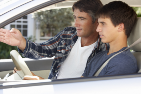 Dad coaching teen son driving