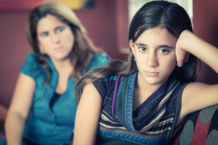 Mother trying to talk to moody teenager