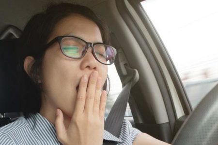 woman yawning while driving