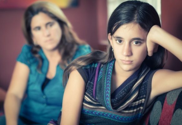 Mother trying to talk to moody teenager