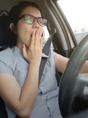 woman yawning while driving