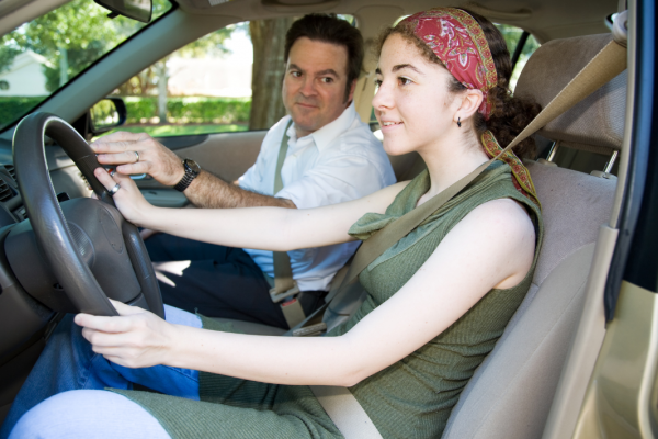 Dad teaching daughter how to drive