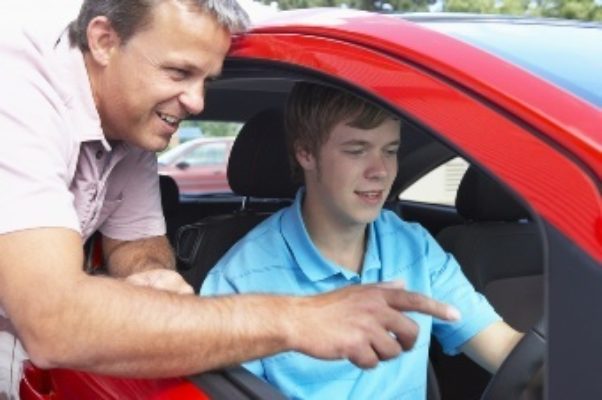 Dad showing son all the features of the car